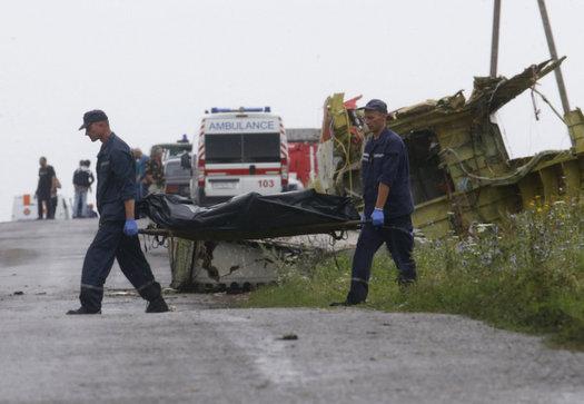 Members of the Ukrainian Emergency Ministry carry a body at the crash site of Malaysia Airlines Flight MH17, near the settlement of Grabovo