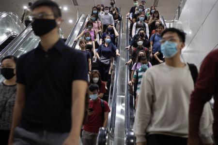 Commuters keep masks on despite lifting of mask rule on public transport