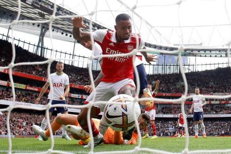 Arsenal beat Spurs to stay top, Liverpool held by Brighton