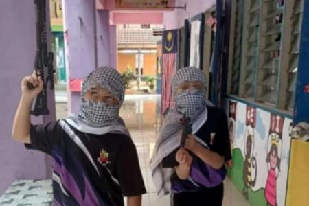 Malaysia’s education ministry probes video showing children and teachers bearing mock firearms