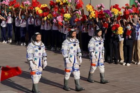 China sends up three astronauts to complete space station