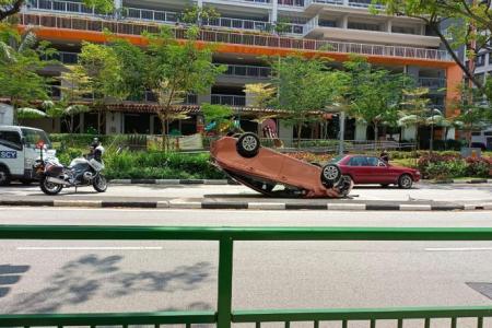 Taxi overturns in Clementi, driver taken to hospital
