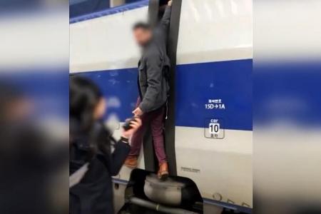 ‘Let me on the train’: Man seen hanging on to moving train in South Korea