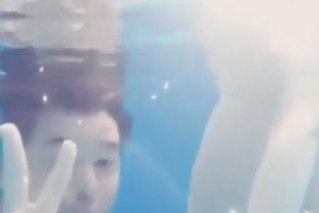 Christopher Lee kisses wife's baby bump underwater