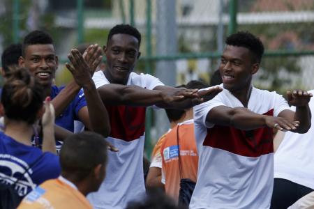 England stars try out Brazilian martial art dance in favela