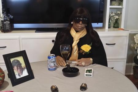 Dead woman sits at party table at her own funeral