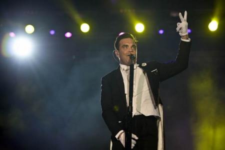 Robbie Williams falls off stage, breaks woman's arm
