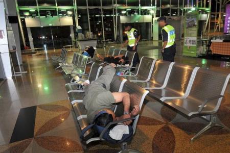 Workers sleep at M'sia immigration after a day's work in S'pore