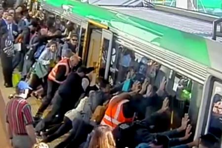 Commuters tilt train to save trapped man