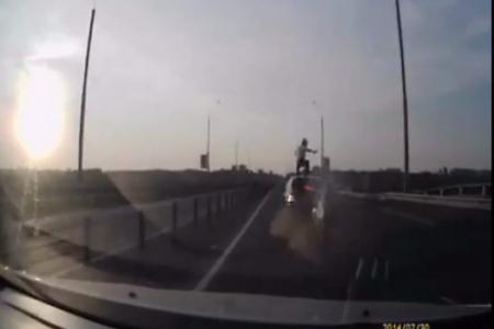 This lucky rider makes acrobatic landing on car after ramming into it 