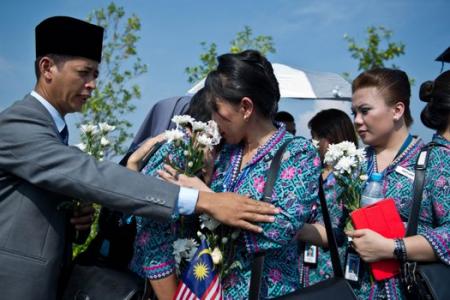 Malaysia falls silent for a minute as remains of 20 MH17 victims return