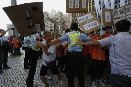 Over 1,000 Macau casino workers stage protest for better pay