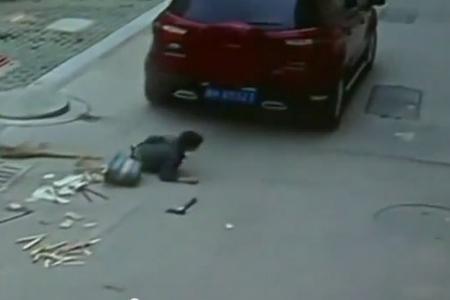 Kid playing in the street gets run over by SUV and walks away