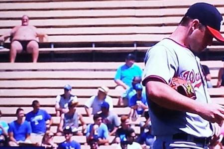 Baseball fan sunbathes nearly nude during game