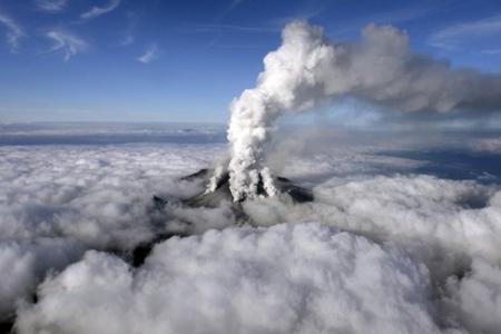 Rescuers rush to reach dozens trapped on erupting Japan volcano