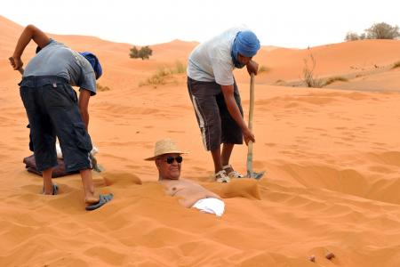 New tourist attraction in Morocco? Burying yourself in the sand dunes
