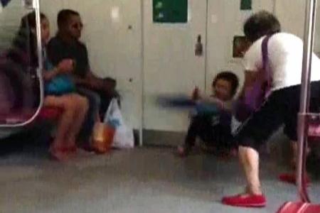 Woman whacks child with umbrella on train