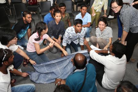 Volunteers teach English to foreign workers at dormitories