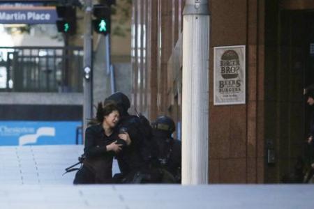Latest: Five hostages run out of Sydney cafe that was taken over by gunman