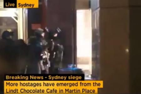 Police storm Sydney cafe, more hostages seen running out
