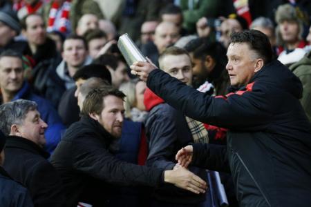 'Santa' Van Gaal revels in Christmas spirit: Gives presents to fans before match
