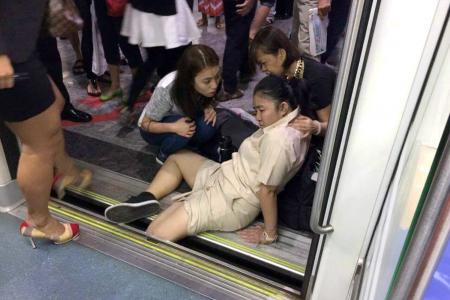 Girl's leg stuck between MRT train and platform