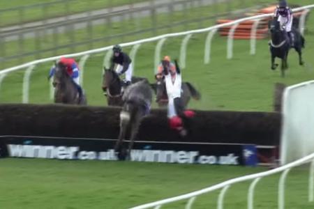 WATCH: Amateur jockey falls off horse, hits fence & somersaults in air, then walks away