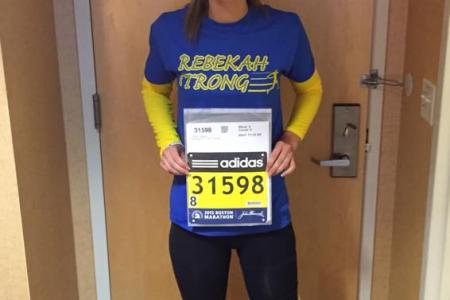 Boston Marathon bombing survivor falls to her knees as she finishes race two years later