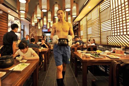 Restaurant in China boosts business by hiring scantily clad servers