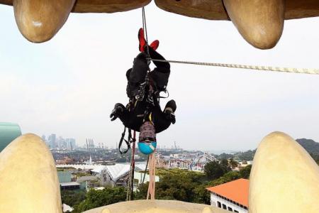 Fear of heights not an option for men cleaning the Merlion in Sentosa
