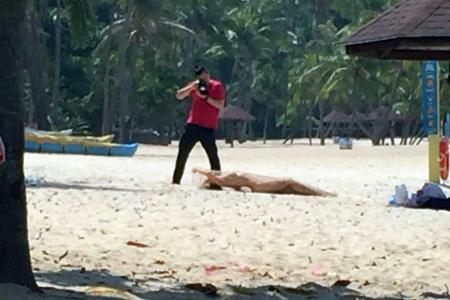 Model stopped while posing nude on Sentosa beach