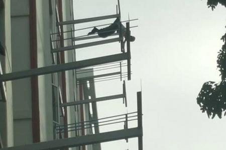Man dangles from eighth storey after clothes snagged by rack