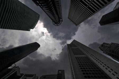  Dark clouds loom over the skyscrapers in Raffles Place