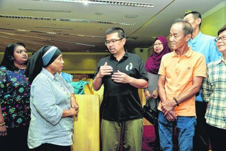 Progressive Wage Model (PWM) change for cleaners; MP Zainal Sapari (in black) with cleaners, including Madam Juniana Ismail (second from left)