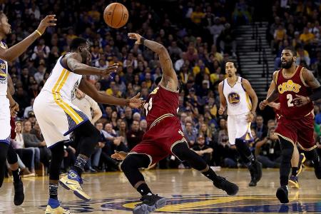 LeBron James falling dramatically after a foul by Draymond Green (left). 