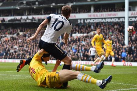 Spurs striker Harry Kane is tackled by Millwall&#039;s English defender Jake Cooper 