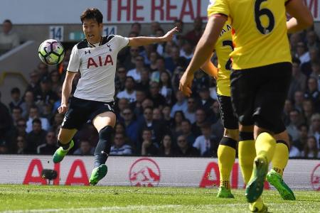 Tottenham Hotspur&#039;s South Korean striker Son Heung-Min (L) prpepares to volley the ball to score his team&#039;s fourth, and his second goal against Watford
