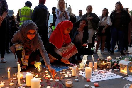 Manchester shows defiance and strength at town hall vigil