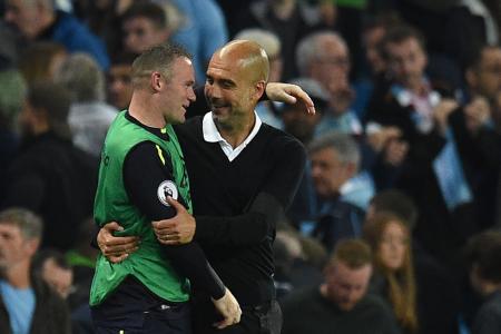 Manchester City manager Pep Guardiola and Everton&#039;s Wayne Rooney chat