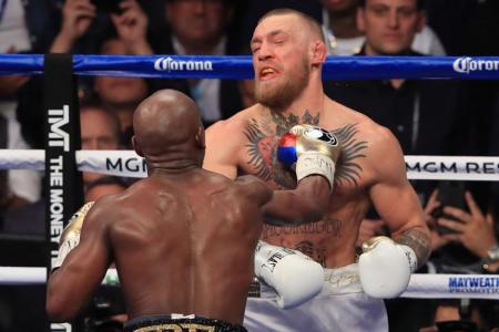 Floyd Mayweather Jr. throws a punch at Conor McGregor 
