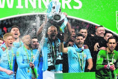 Manchester City players celebrating their League Cup win – the first silverware the Citizens have secured under manager Pep Guardiola, who is in his second season at the Etihad