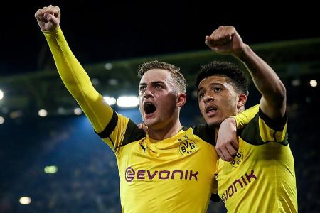 Dortmund survive onslaught to go three points clear