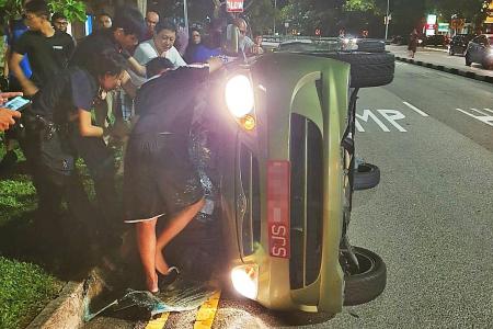 Passers-by rush to save occupants of overturned car