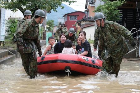 At least two dead as 900,000 flee floods in Japan