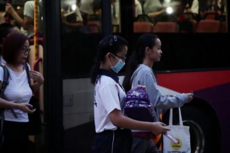 A student from Nanhua Primary School wearing a mask while walking to school on Sept 16, 2019.