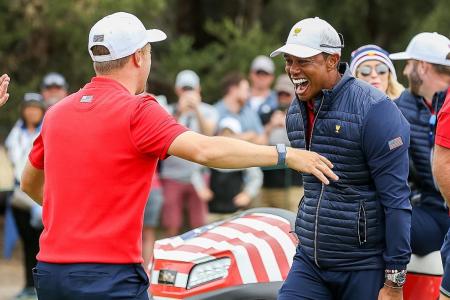 Playing captain Tiger Woods hugging teammate Justin Thomas (left) after the Americans&#039; Presidents Cup victory.