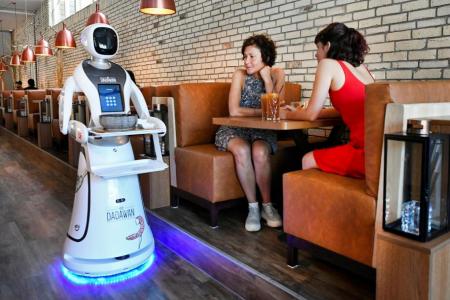 Robots dish out drinks at reopened Dutch restaurant