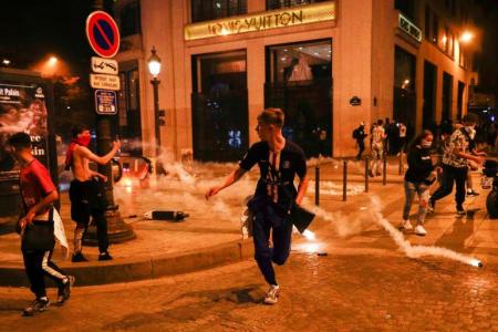 Tale of two cities: Euphoria in Munich, sadness and tear gas in Paris