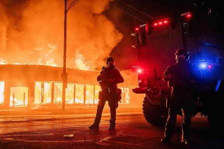 Buildings on fire as US city rages over police shooting of black man