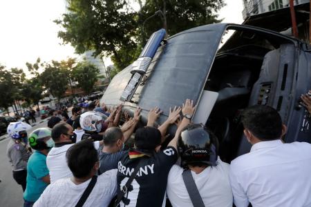 Indonesian cops detain nearly 400 as protests turn violent